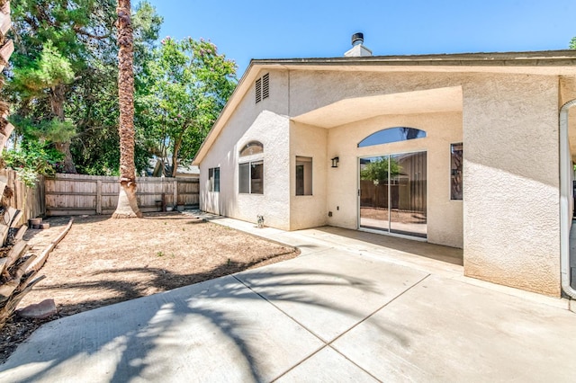 5537 W Oswego Ave, Fresno, CA 93722 - back of property featuring stucco siding, a patio, and a fenced backyard
