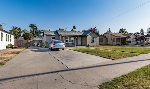 2004 E Clinton Ave, Fresno, CA 93703 - single story home with driveway, a porch, stucco siding, and a residential view