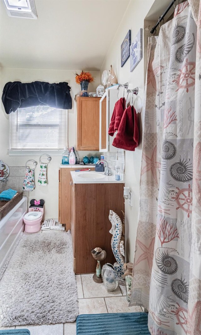 2004 E Clinton Ave, Fresno, CA 93703 - full bathroom featuring vanity, tile patterned floors, and a shower with shower curtain