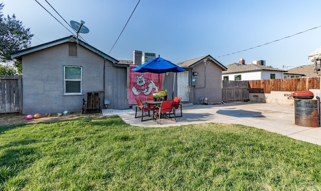 2004 E Clinton Ave, Fresno, CA 93703 - back of house with a fenced backyard, a patio, and stucco siding