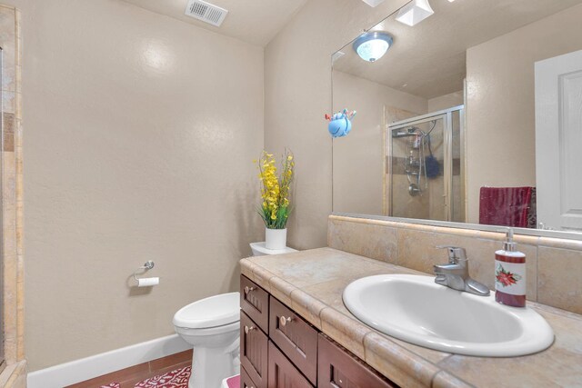 3017 W Oleander Ave, Fresno, CA 93706 - bathroom featuring a shower stall, vanity, wood finished floors, and decorative backsplash