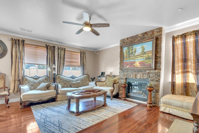 3017 W Oleander Ave, Fresno, CA 93706 - living room with ceiling fan, crown molding, wood finished floors, and a stone fireplace