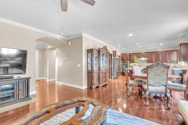 3017 W Oleander Ave, Fresno, CA 93706 - living area featuring arched walkways, light wood finished floors, recessed lighting, ornamental molding, and a ceiling fan