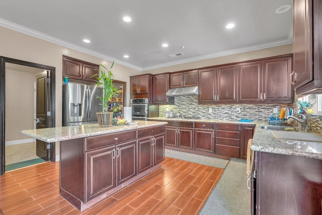 3017 W Oleander Ave, Fresno, CA 93706 - kitchen featuring appliances with stainless steel finishes, under cabinet range hood, backsplash, light stone counters, and light wood-type flooring