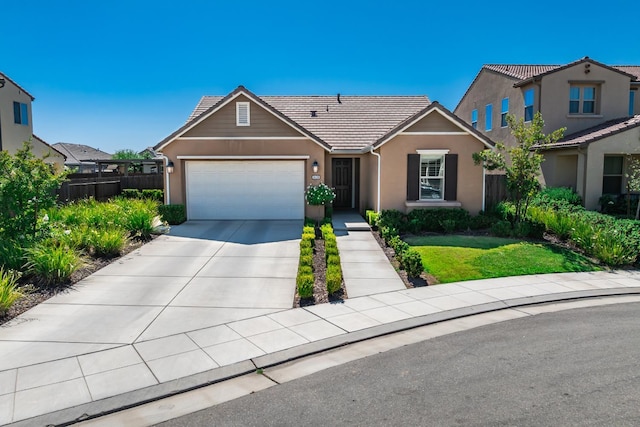 3430 Hermosa Ave, Clovis, CA 93619 - view of front of home featuring an attached garage, driveway, stucco siding, and a tiled roof