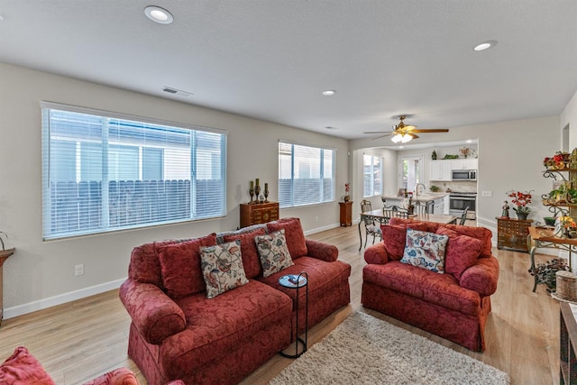 7387 E Robinson Ave, Fresno, CA 93737 - living area with light wood-type flooring, ceiling fan, and recessed lighting