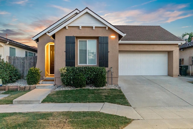 7387 E Robinson Ave, Fresno, CA 93737 - view of front facade featuring an attached garage, stucco siding, and concrete driveway