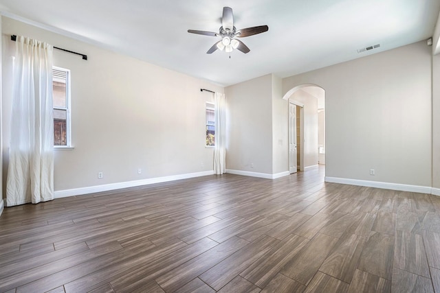 1552 N Gateway Ave, Clovis, CA 93619 - empty room with ceiling fan, arched walkways, and wood finished floors