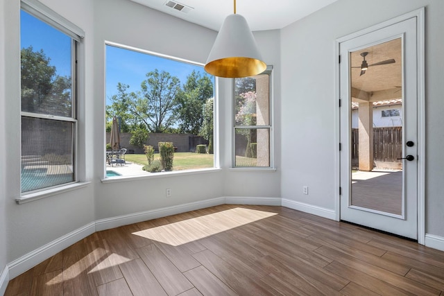 1552 N Gateway Ave, Clovis, CA 93619 - unfurnished dining area featuring wood finished floors, plenty of natural light, and a ceiling fan