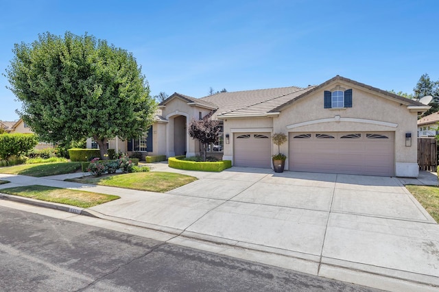 1552 N Gateway Ave, Clovis, CA 93619 - view of front of home with a garage, concrete driveway, stucco siding, and a tile roof