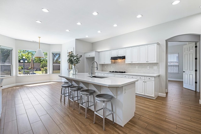 1552 N Gateway Ave, Clovis, CA 93619 - kitchen featuring under cabinet range hood, recessed lighting, black stovetop, light countertops, and white cabinetry