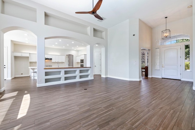 1552 N Gateway Ave, Clovis, CA 93619 - unfurnished living room featuring a high ceiling, dark wood finished floors, and a ceiling fan