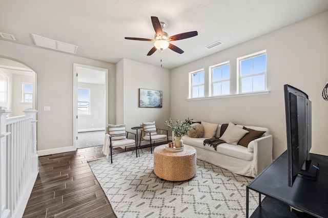 974 Talus Way S, Madera, CA 93636 - living room with ceiling fan, dark wood-style flooring, and arched walkways