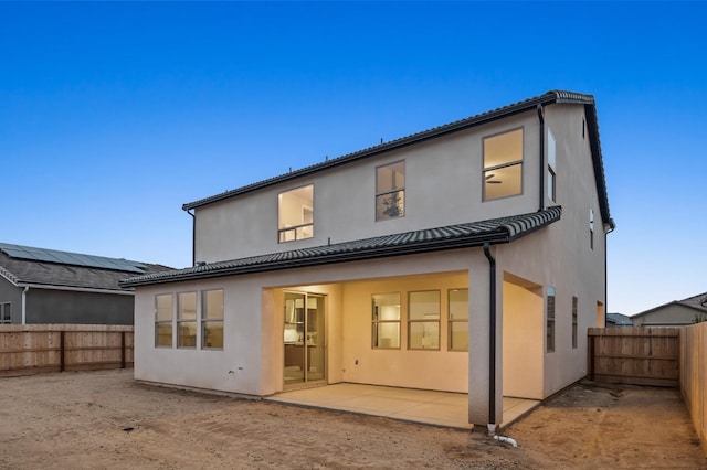 974 Talus Way S, Madera, CA 93636 - back of property featuring stucco siding, a fenced backyard, and a patio