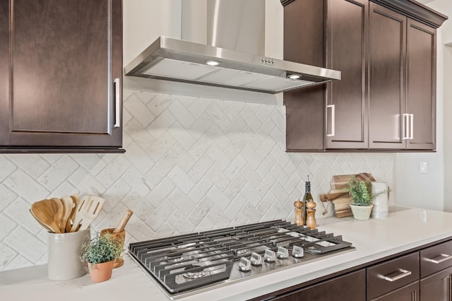 974 Talus Way S, Madera, CA 93636 - kitchen featuring wall chimney exhaust hood, stainless steel gas stovetop, dark brown cabinetry, and light countertops