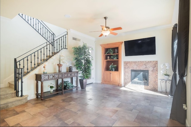 1682 N Dutch Ave, Clovis, CA 93619 - living area featuring a ceiling fan, built in features, stairway, stone finish flooring, and a fireplace