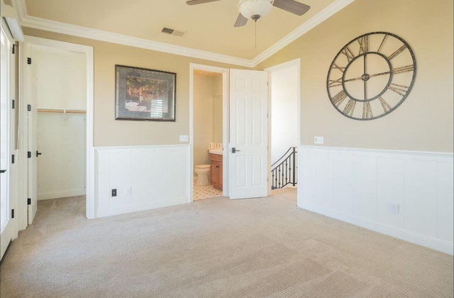1682 N Dutch Ave, Clovis, CA 93619 - unfurnished bedroom featuring carpet floors, ornamental molding, a decorative wall, wainscoting, and a walk in closet