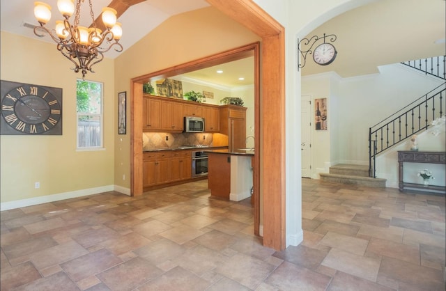 1682 N Dutch Ave, Clovis, CA 93619 - kitchen featuring appliances with stainless steel finishes, stone tile flooring, dark countertops, a chandelier, and brown cabinets
