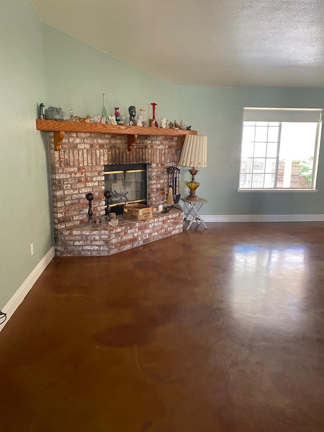 5288 N Piedra Rd N, Sanger, CA 93657 - unfurnished living room featuring a brick fireplace, vaulted ceiling, and a textured ceiling