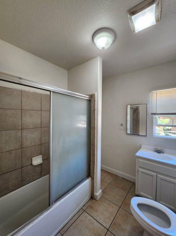 5288 N Piedra Rd N, Sanger, CA 93657 - full bathroom with shower / bath combination with glass door, tile patterned flooring, a textured ceiling, and vanity