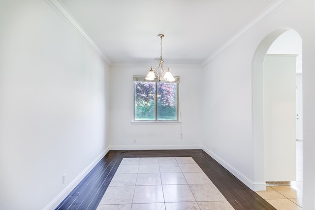 1090 Clara Ave, Fowler, CA 93625 - empty room with a chandelier, arched walkways, ornamental molding, and wood finished floors
