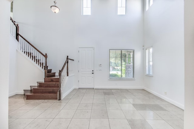 1090 Clara Ave, Fowler, CA 93625 - entrance foyer with a high ceiling, stairway, and light tile patterned flooring