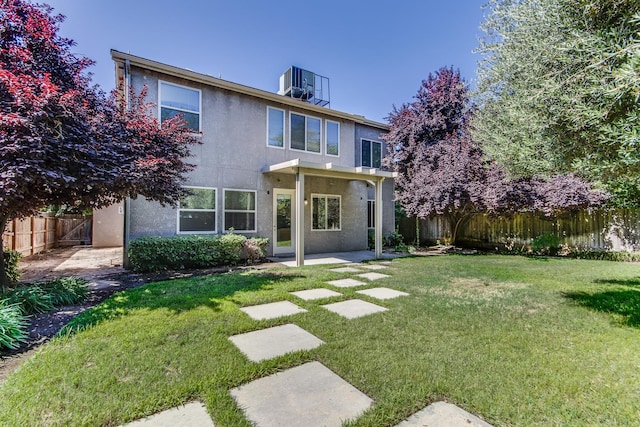 1090 Clara Ave, Fowler, CA 93625 - back of property with a fenced backyard, stucco siding, and a patio