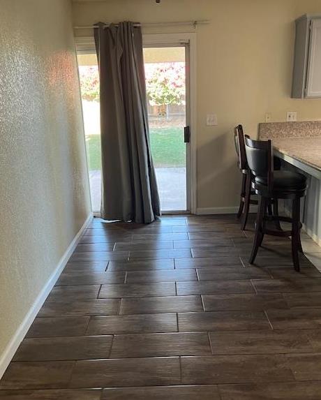 6324 N Brix, Fresno, CA 93722 - dining area featuring wood tiled floors and a textured wall