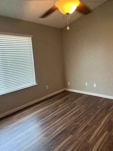 6324 N Brix, Fresno, CA 93722 - unfurnished room featuring dark wood finished floors and ceiling fan