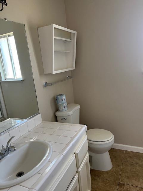 6324 N Brix, Fresno, CA 93722 - half bathroom with vanity and tile patterned flooring