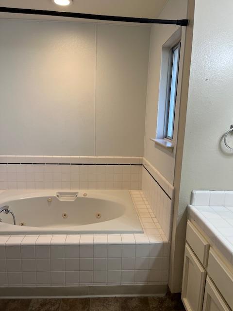 6324 N Brix, Fresno, CA 93722 - bathroom featuring a tub with jets and vanity
