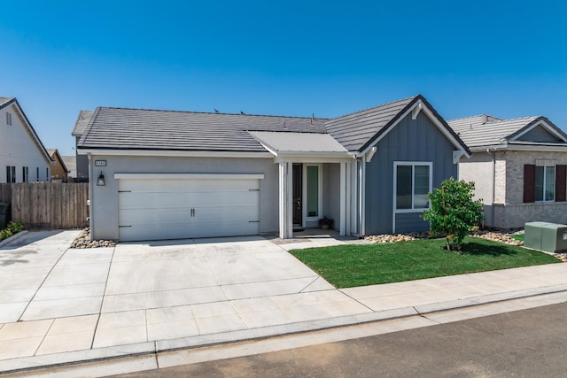4146 Dennis Ave, Clovis, CA 93619 - ranch-style home with board and batten siding, a garage, driveway, and a tiled roof