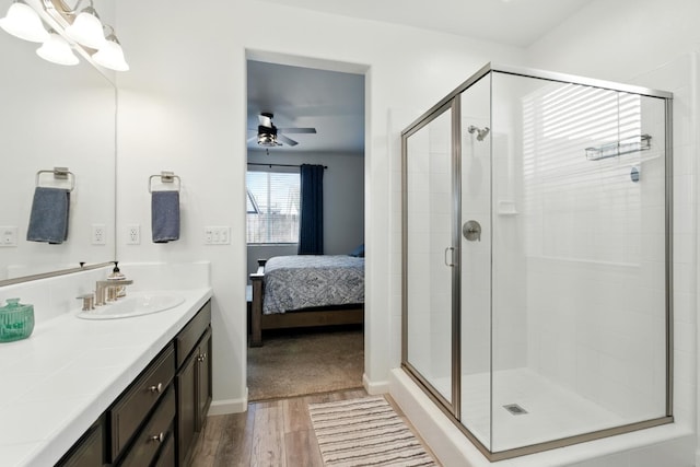 4146 Dennis Ave, Clovis, CA 93619 - ensuite bathroom featuring vanity, wood finished floors, a stall shower, a ceiling fan, and a chandelier