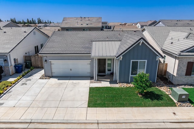 4146 Dennis Ave, Clovis, CA 93619 - view of front of property featuring board and batten siding, an attached garage, driveway, and a residential view