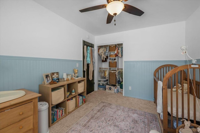 1448 Ashcroft Ave, Clovis, CA 93611 - bedroom featuring a wainscoted wall, a closet, carpet floors, and a ceiling fan
