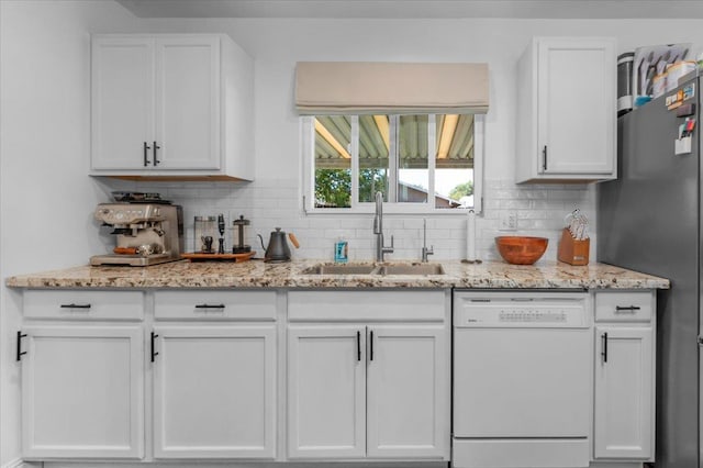 1448 Ashcroft Ave, Clovis, CA 93611 - kitchen featuring white dishwasher, white cabinetry, tasteful backsplash, and light stone countertops