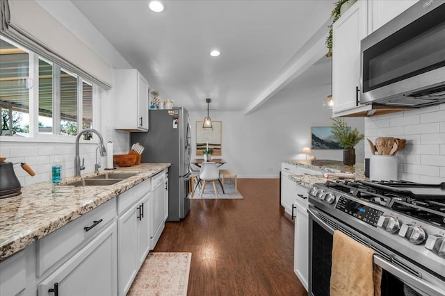 1448 Ashcroft Ave, Clovis, CA 93611 - kitchen featuring stainless steel appliances, decorative backsplash, dark wood-type flooring, white cabinetry, and recessed lighting