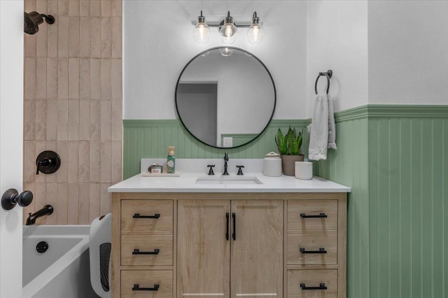 1448 Ashcroft Ave, Clovis, CA 93611 - bathroom featuring a wainscoted wall, vanity, and bathtub / shower combination