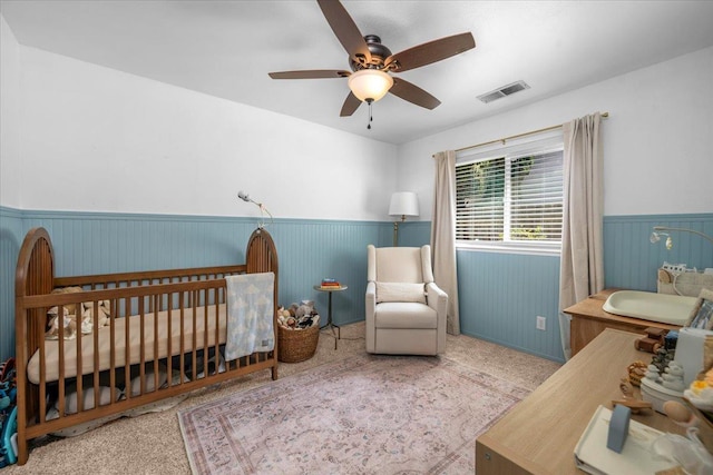 1448 Ashcroft Ave, Clovis, CA 93611 - bedroom with wainscoting, a nursery area, and ceiling fan