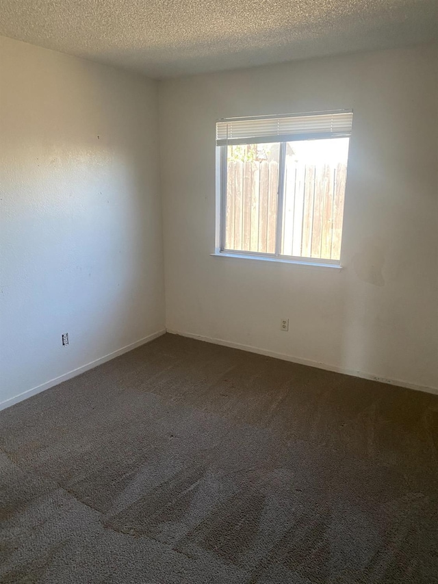 2673 N Marty Ave, Fresno, CA 93722 - empty room featuring carpet flooring and a textured ceiling