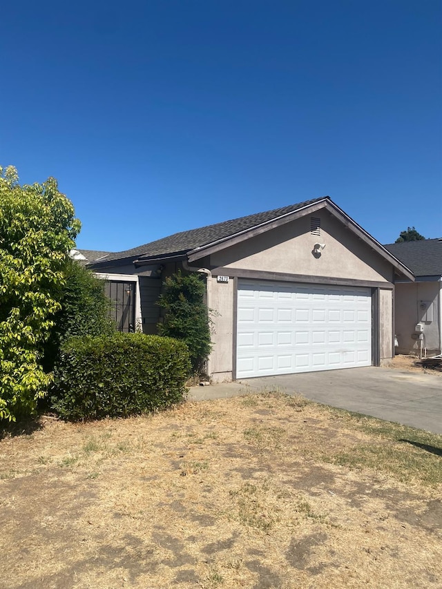 2673 N Marty Ave, Fresno, CA 93722 - single story home featuring concrete driveway, an attached garage, and stucco siding