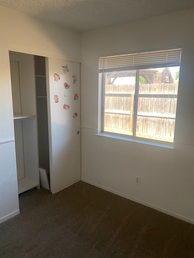 2673 N Marty Ave, Fresno, CA 93722 - unfurnished bedroom with carpet floors, a closet, and a textured ceiling