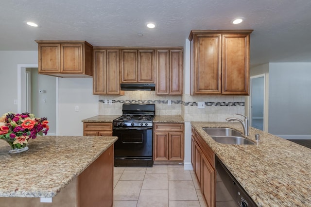 1437 N San Pablo Ave, Fresno, CA 93728 - kitchen with black gas stove, under cabinet range hood, brown cabinetry, and recessed lighting