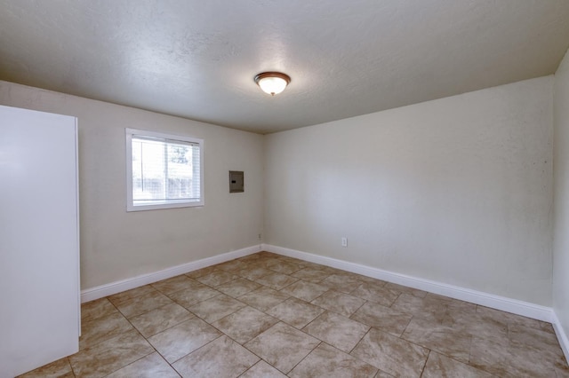 1437 N San Pablo Ave, Fresno, CA 93728 - empty room with electric panel, a textured ceiling, and light tile patterned flooring