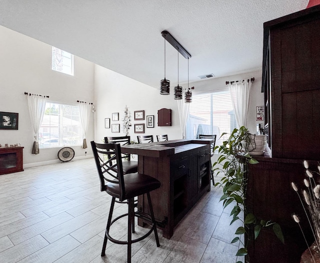 2457 Carson Ave, Clovis, CA 93611 - kitchen with wood finished floors, hanging light fixtures, and a textured ceiling