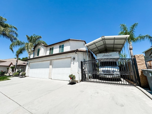 2457 Carson Ave, Clovis, CA 93611 - view of front of home with a garage, driveway, stucco siding, and a gate