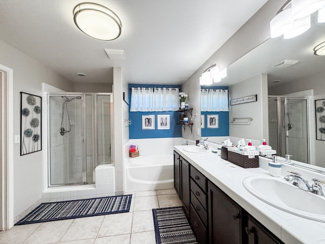 2457 Carson Ave, Clovis, CA 93611 - bathroom featuring a bath, a shower stall, double vanity, and tile patterned floors