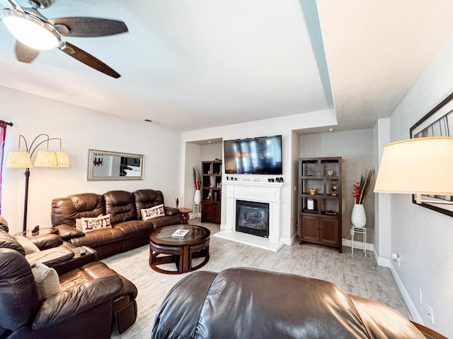 2457 Carson Ave, Clovis, CA 93611 - living room with a ceiling fan, light wood-type flooring, and a glass covered fireplace