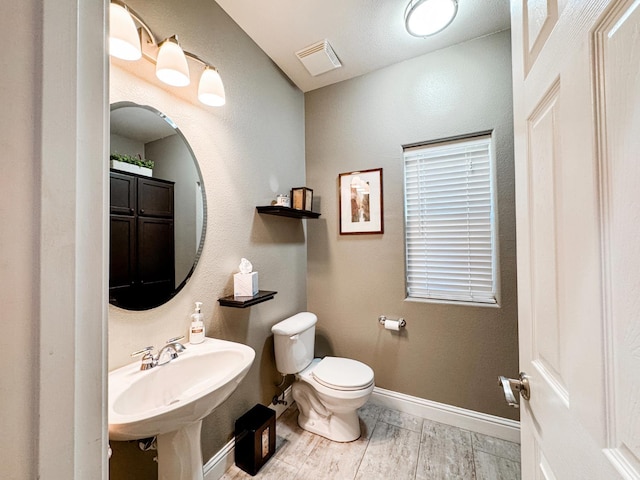 2457 Carson Ave, Clovis, CA 93611 - half bath featuring toilet and wood finished floors
