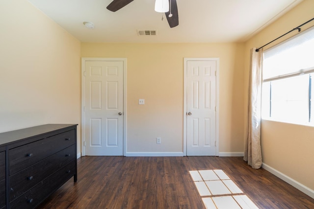 4115 E Montecito Ave, Fresno, CA 93702 - unfurnished bedroom with dark wood-type flooring and ceiling fan